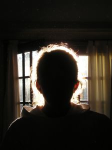 Silhouette of person in front of window