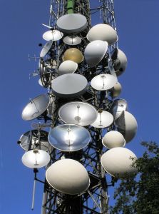Antenna tower covered with 100 antennas of various shapes and sizes