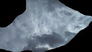 Triangular view of sky bordered by Double Arch rock formations