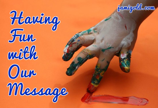 Child fingerpainting with text: Having Fun with Our Message